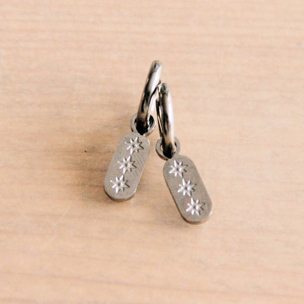 Stainless steel creoles with tag and stars